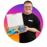 Man with down syndrome in black t shirt shows open box with socks bundle